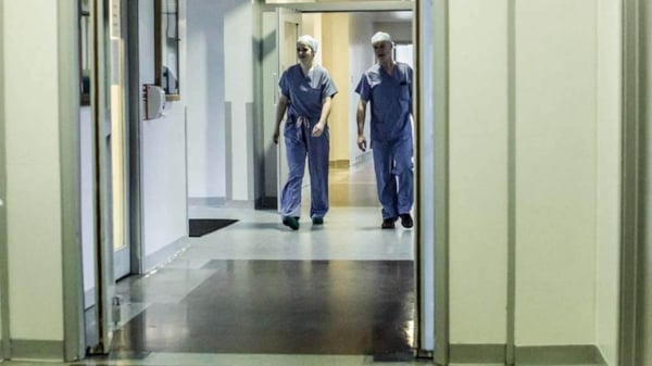 Doctors walking through a hospital ward